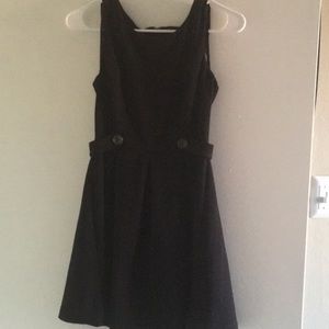 Sleeveless black dress with button detail